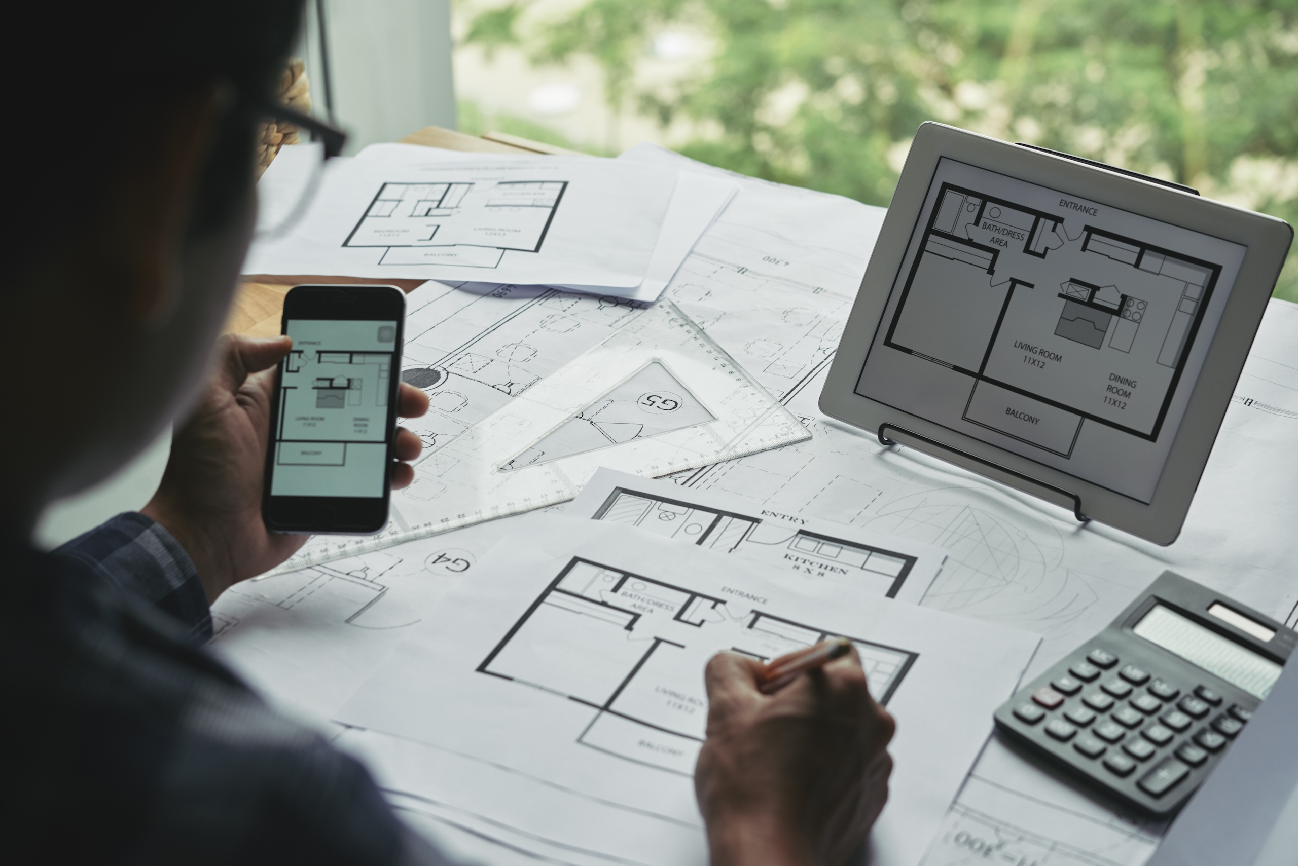 Many blueprints of apartments on table of professional architect